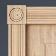 an unfinished wooden door frame with decorative molding