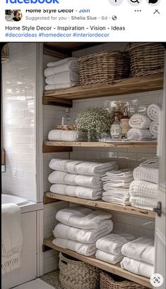 a bathroom with shelves filled with white towels