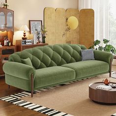 a living room filled with furniture and a rug on top of a hard wood floor