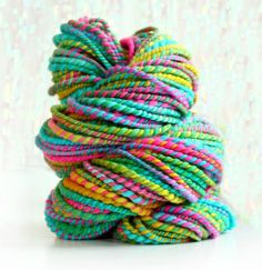 multicolored spoole of yarn on white background