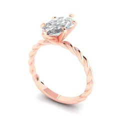 a rose gold engagement ring with an oval cut diamond in the center and twisted band