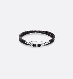 The double bracelet is distinguished by a bold and modern two-material design. The style features a braided cord in black lambskin enhanced by the CD Icon signature in silver-finish brass and a hook clasp. The bracelet can be paired with other creations from the collection.. L Cd Icon, Mens Accessories Bracelet, Double Bracelet, Brass Hook, Braided Leather Bracelet, Bracelet Black, Hook Clasp, Braided Leather, Material Design