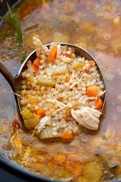 a spoon full of chicken and rice soup