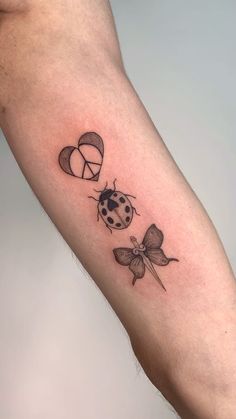 a lady bug tattoo on the left arm