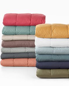 four different colored sheets stacked on top of each other in various sizes and colors, all folded together