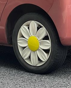 a red car with white flowers on it's tire