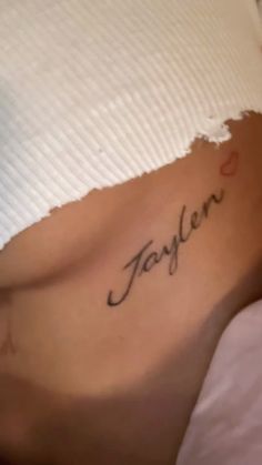 a woman's stomach with the word taylor written in cursive writing on it