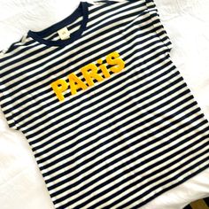 Navy Blue/White Stripe With Yellow “Paris”. No Tags But Never Worn Navy Tops With Letter Print For Spring, H&m Spring Tops With Letter Print, H&m Spring Letter Print Tops, H&m Tops With Letter Print For Spring, Blue Crew Neck Tops By H&m, Blue Crew Neck Top From H&m, Sporty Spring Tops From H&m, Sporty Spring Tops By H&m, Sporty H&m Tops For Spring