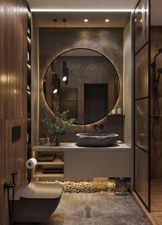 a bathroom with a round mirror above the sink and a bathtub next to it