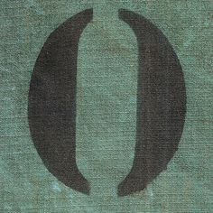 the letter u is made up of black letters on a green background with an oval shape