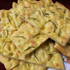 there are crackers that have been placed on a plate with some rosemary sprigs