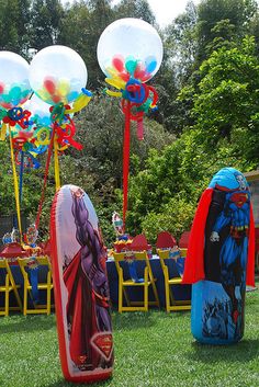 an outdoor party with balloons and decorations