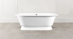 a white bath tub sitting on top of a wooden floor