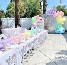 a table set up with balloons and cake