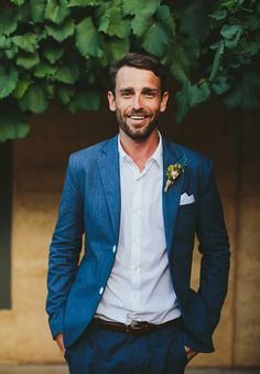 a man in a blue suit and white shirt