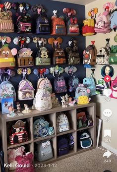 a room filled with lots of purses on shelves next to a wall covered in cartoon characters