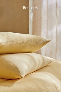 two pillows sitting on top of a bed with the words bonsoirs above them