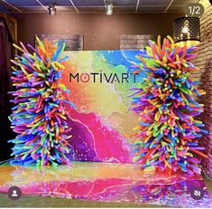 two large colorful decorations on display in front of a wall with the words motivvari