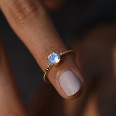 "Moonstone Engagement Ring/Round Rainbow Moonstone Ring/14k Gold Promise Ring/Dainty Moonstone Ring/Moonstone Jewelry/June Birthstone Jewelry ★ ★ ★ ★ CUSTOM/DUTY FREE SHIPPING WORLDWIDE, BUYERS DON'T HAVE TO PAY ANY CUSTOM FEES WHILE IMPORTING ★ ★ ★ ★ Details Made to order Material: 14k/18k gold Color Options: Yellow Gold, White Gold, Rose Gold, ★ Center Stone Rainbow Moonstone Round Size: 5.5 mm Approx Weight (Ct): 0.59 ★ Accent Stones Diamond Round Size: 1.5 mm * 2 No.s Approx Weight (Ct): 0.0 Yellow Gold Moonstone Ring With Gemstone Accents, Moonstone Promise Ring With Gemstone Accents, Dainty Moonstone Halo Ring, Dainty Moonstone Birthstone Ring, Rainbow Moonstone Engagement Ring, Gold Promise Ring, Engagement Ring Round, Ring Moonstone, Moonstone Ring Sterling Silver