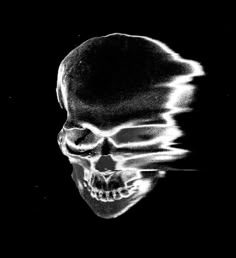 a black and white photo of a skull with its head turned to the side, in front of a dark background