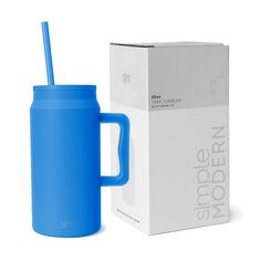 a blue mug with a straw in it next to a box