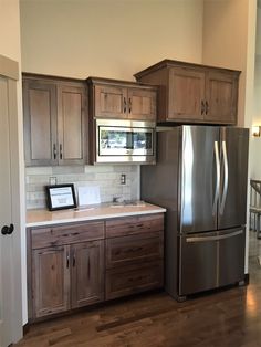 a kitchen with wooden cabinets and stainless steel appliances