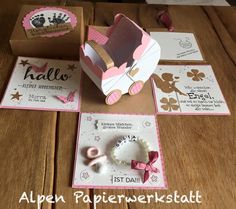 an open box on a table with some cards and other items around it that include a baby's first birthday card