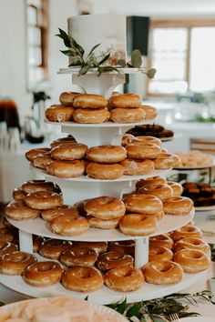 a tiered cake with lots of donuts on it