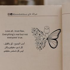 an open book with a butterfly and flowers on the page, in arabic writing that reads love all, trust tew, everything's real but not everyone true