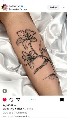 a woman's arm with a flower tattoo on it