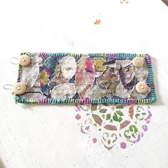 a patchwork purse with buttons on it