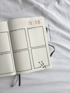 an open planner book on a white sheet