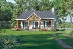 a small house in the middle of a grassy area with trees and bushes around it