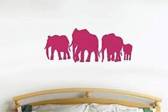 three pink elephants standing in front of a white wall with the word elephant on it's side