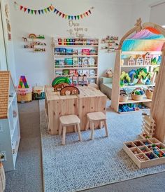 a child's playroom with toys and bookshelves