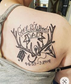 the back of a woman's shoulder with an arrow and some words on it