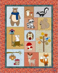 a quilted wall hanging with animals and trees on it's sides, including an owl