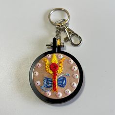 a keychain with an embroidered design on it