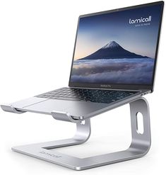 an open laptop computer sitting on top of a metal stand