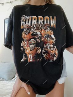 a woman wearing a black shirt with an image of two football players on it