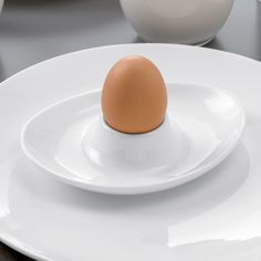 an egg sitting on top of a white plate