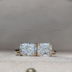 an engagement ring with three princess cut diamonds