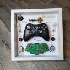 a game controller and circuit board in a shadow box