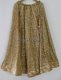 Gold Saree Dress With Mirror Work, Semi-stitched Gold Embroidered Sharara For Party, Party Semi-stitched Sharara With Gold Embroidery, Semi-stitched Sharara With Gold Embroidery For Party, Gold Sharara With Mirror Work In Georgette, Party Sharara With Gold Embroidery, Bollywood Style Gold Embroidered Sharara For Party, Gold Sequin Dress For Diwali, Gold Bollywood Dress With Sequins