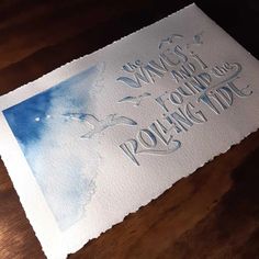 a piece of paper that has some type of writing on it with watercolor paint