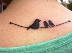 two birds sitting on a branch tattoo