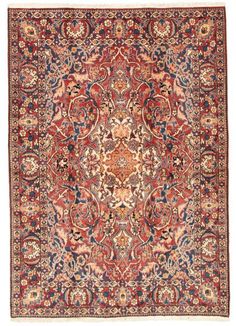 an antique persian rug with red and blue colors