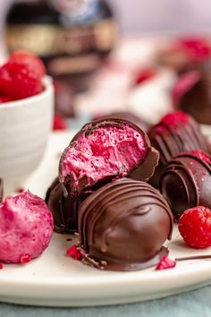 chocolates and raspberries on a white plate