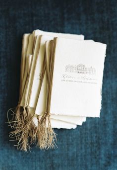 four folded books with tassels on top of them