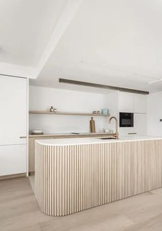 a kitchen with white walls and wooden flooring next to a counter top on a hard wood floor